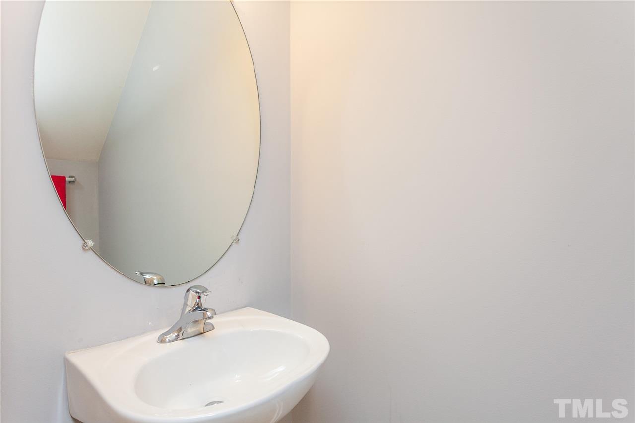1408 Ricochet Drive Raleigh, NC 27610 - Photo 14 of 25 a bathroom with a sink and mirror