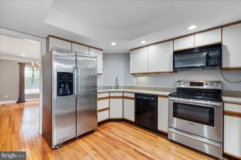 a kitchen with stainless steel appliances granite countertop a stove refrigerator and microwave