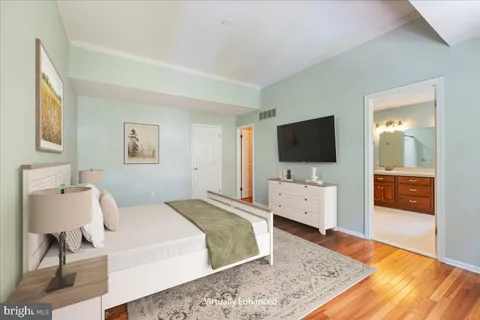 a bedroom with a flat screen tv and a bed