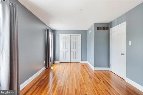 a view of a room with wooden floor
