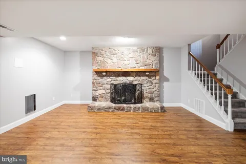 a view of empty room with fireplace and windows