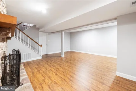 a view of a room with wooden floor and white walls