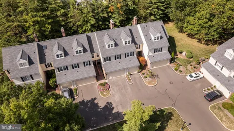 an aerial view of a house with garden space and street view