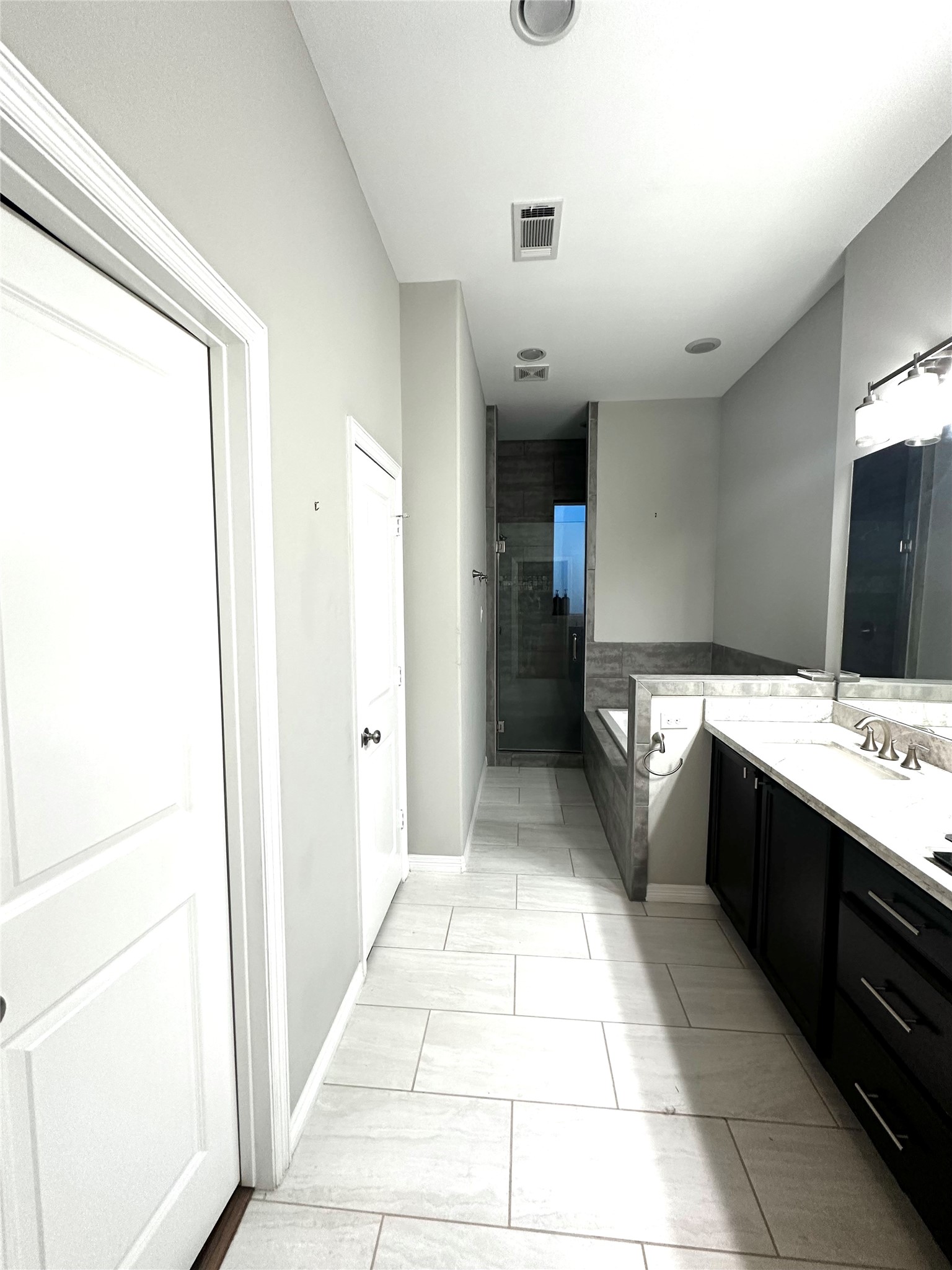 1621 Shearn Street Houston, TX 77007 - Photo 22 of 45 a large bathroom with a double vanity sink toilet and a mirror
