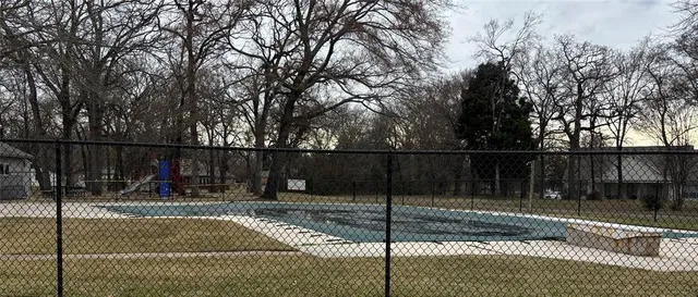 a view of a house with large trees