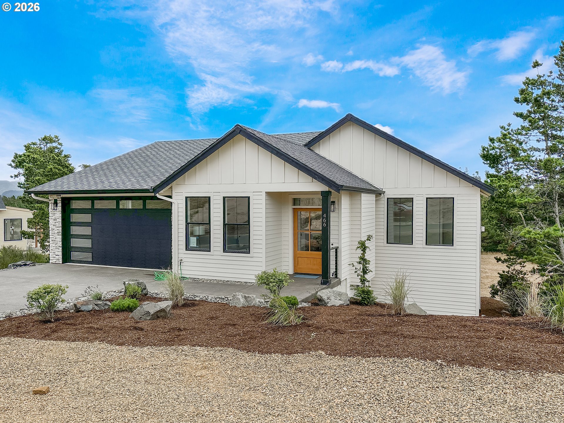 466 Meadows Drive Nehalem, OR 97131 - Photo 1 of 28 a front view of a house with yard and parking