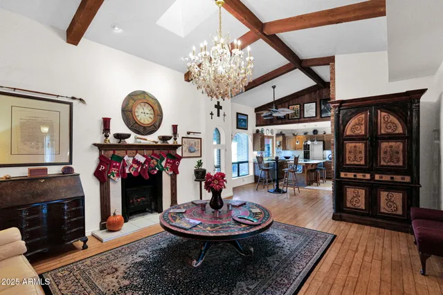 a living room with furniture a fireplace and next to a window