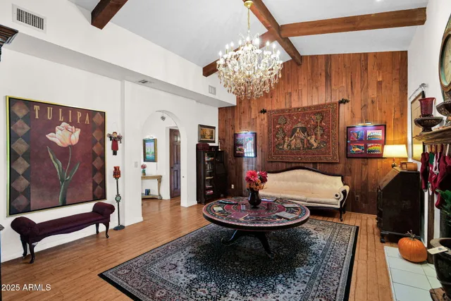 a living room with furniture and a chandelier