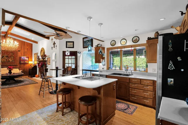 a dining hall with stainless steel appliances granite countertop a sink and a refrigerator