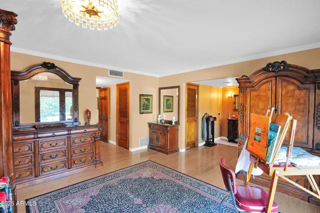 a living room with furniture a rug and painting on the wall