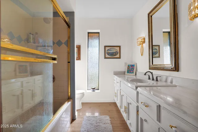 a bathroom with a double vanity sink and a mirror