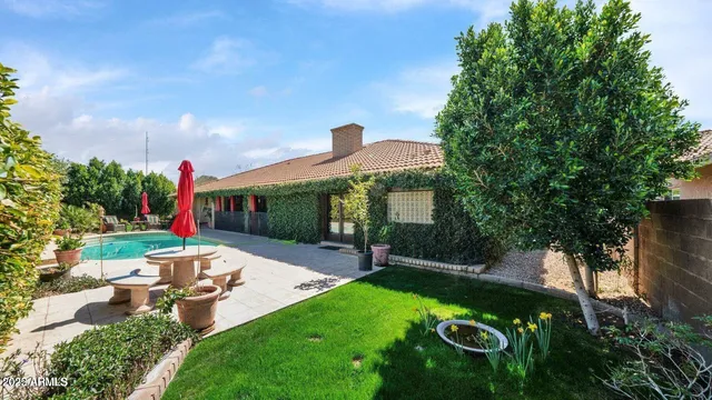 a view of a backyard with sitting area