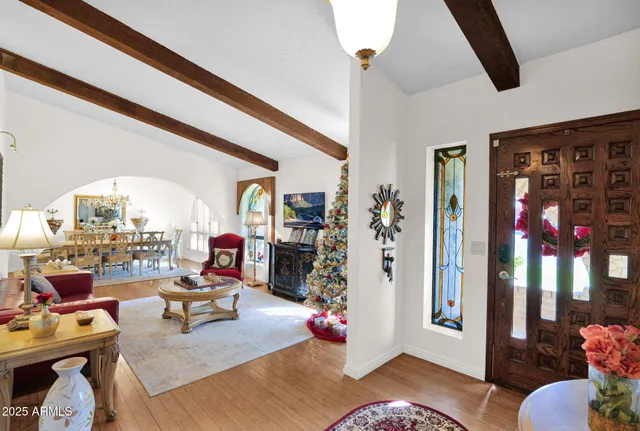 a living room with lots of furniture and a chandelier