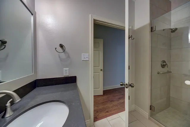 a bathroom with a sink and shower