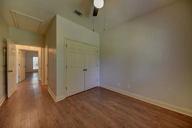 a view of a hallway with wooden floor