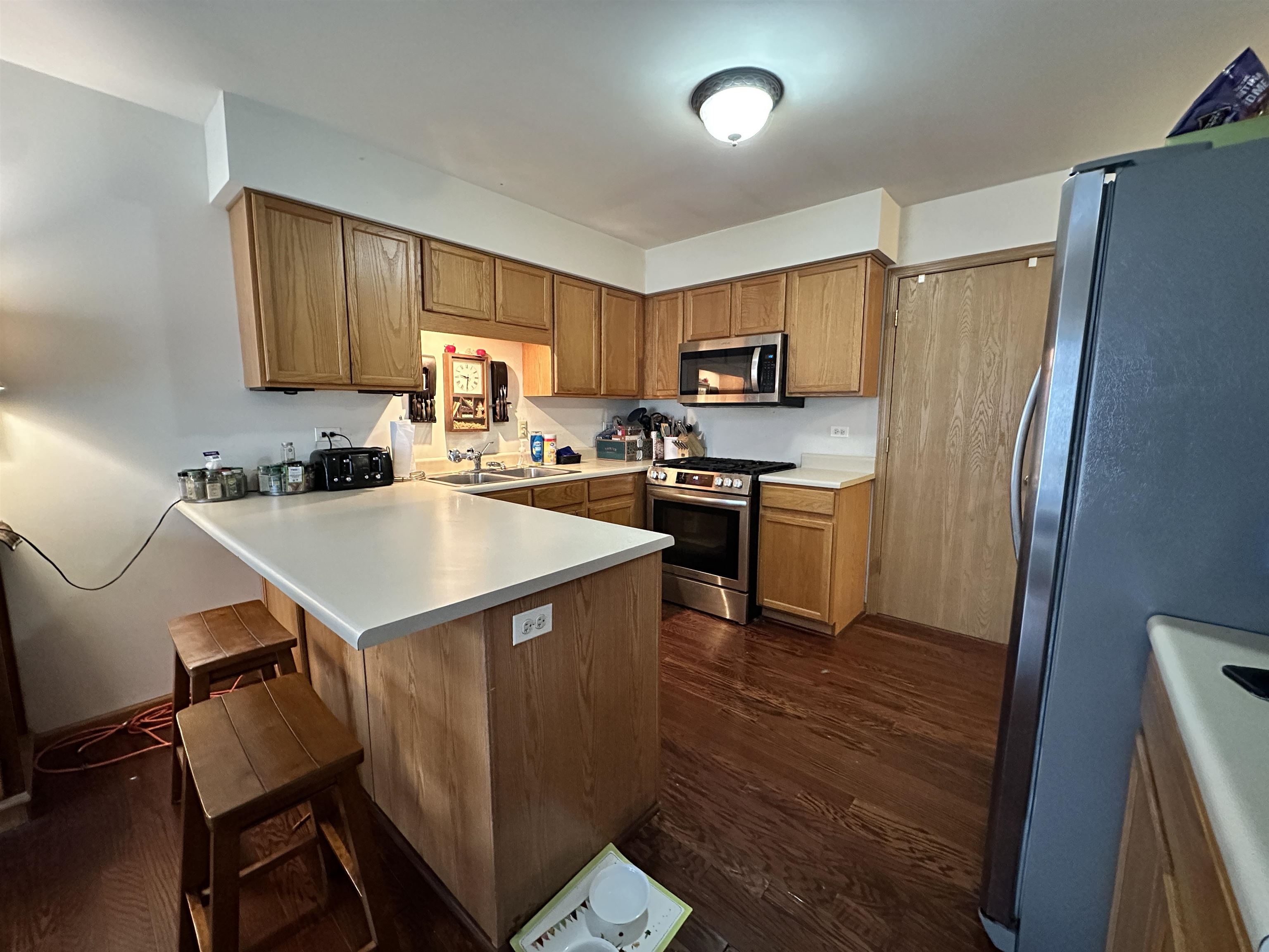 47 D Rolling Oaks Road Sugar Grove, IL 60554 - Photo 10 of 23 a kitchen with a sink a stove a refrigerator cabinets and a dining table