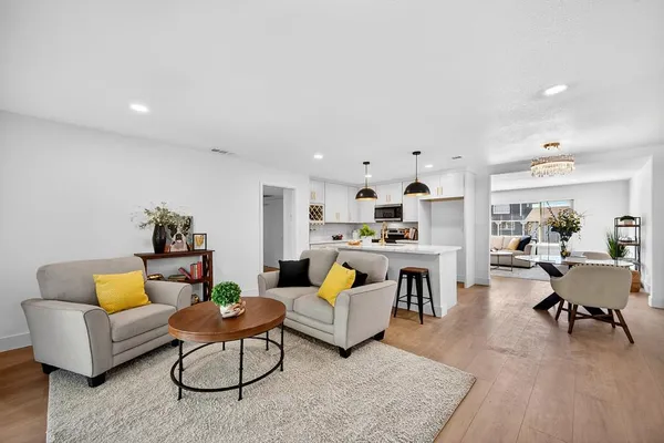a living room with fireplace furniture and a wooden floor