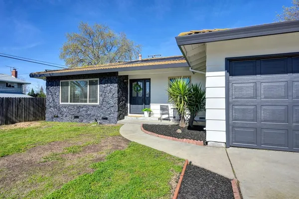 a front view of a house with garden