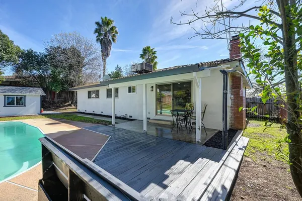 a view of a backyard with large trees