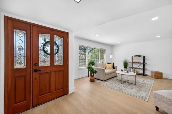 a living room with furniture and large window