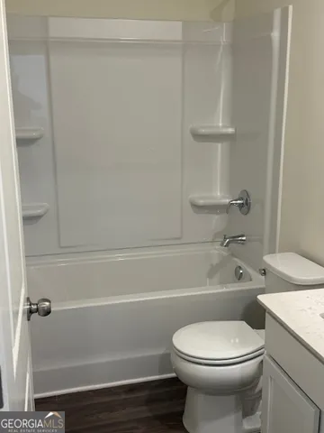 a bathroom with a toilet a sink and bathtub