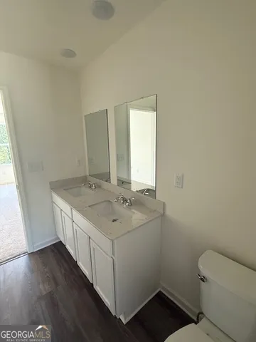 a bathroom with a sink toilet and window