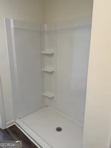 a view of a room with window and a fan