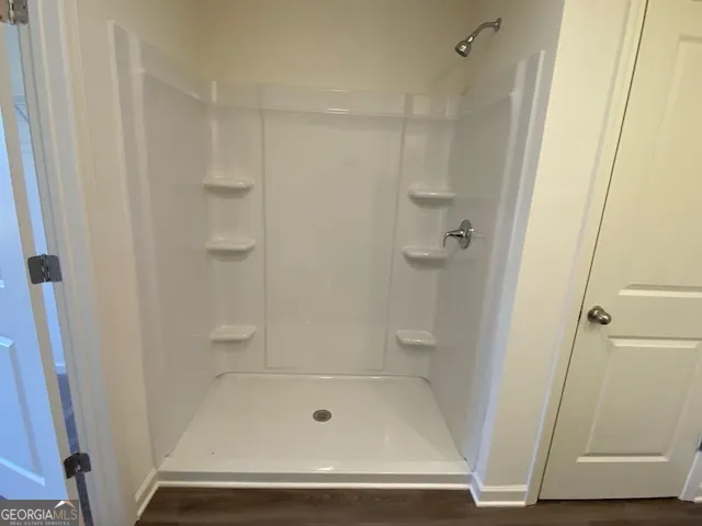 an empty room with windows and closet