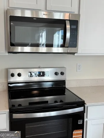 a stove top oven sitting inside of a kitchen
