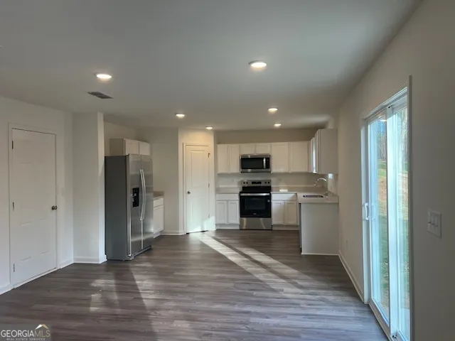a view of kitchen with wooden floor
