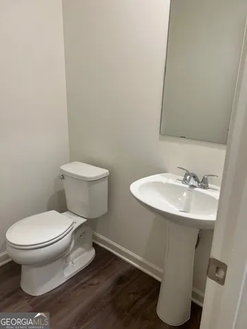 a white toilet sitting next to a bathroom sink