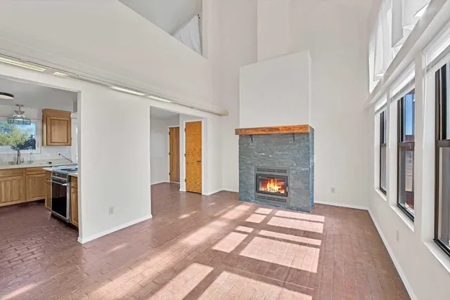 a view of an empty room fire place and a window