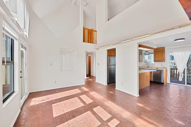 a view of a livingroom with kitchen and furniture