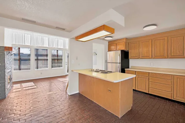 a kitchen with cabinets and wooden floor