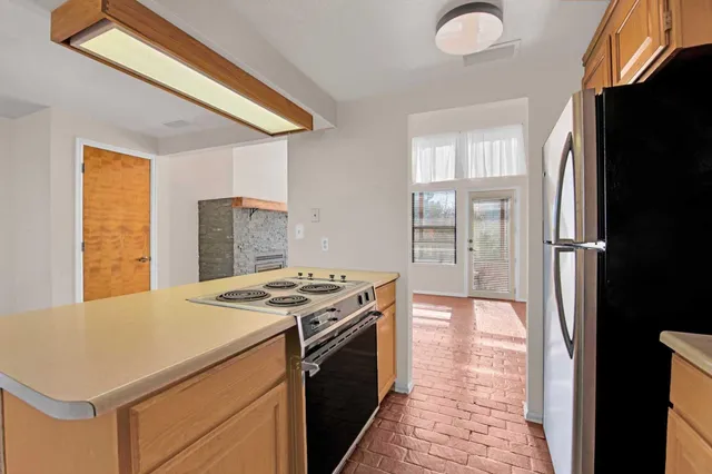 a kitchen that has a stove and a refrigerator