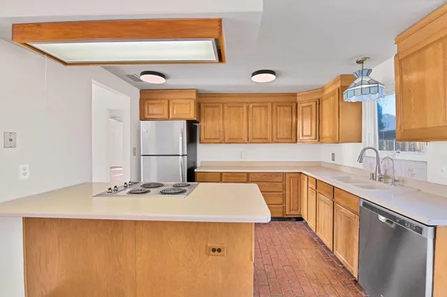 a kitchen with a sink a stove and cabinets