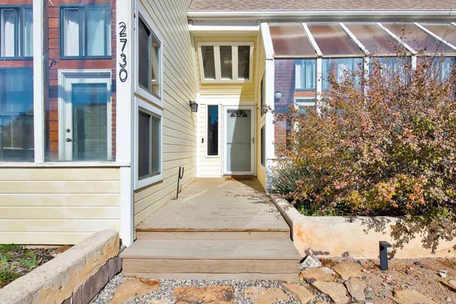 a view of a brick house with many windows