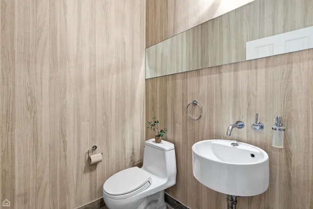 a bathroom with a toilet a sink and a mirror