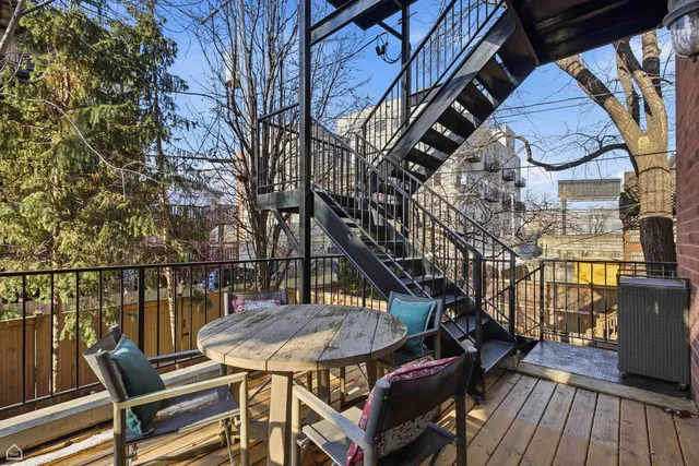 a terrace with outdoor seating and wooden floor
