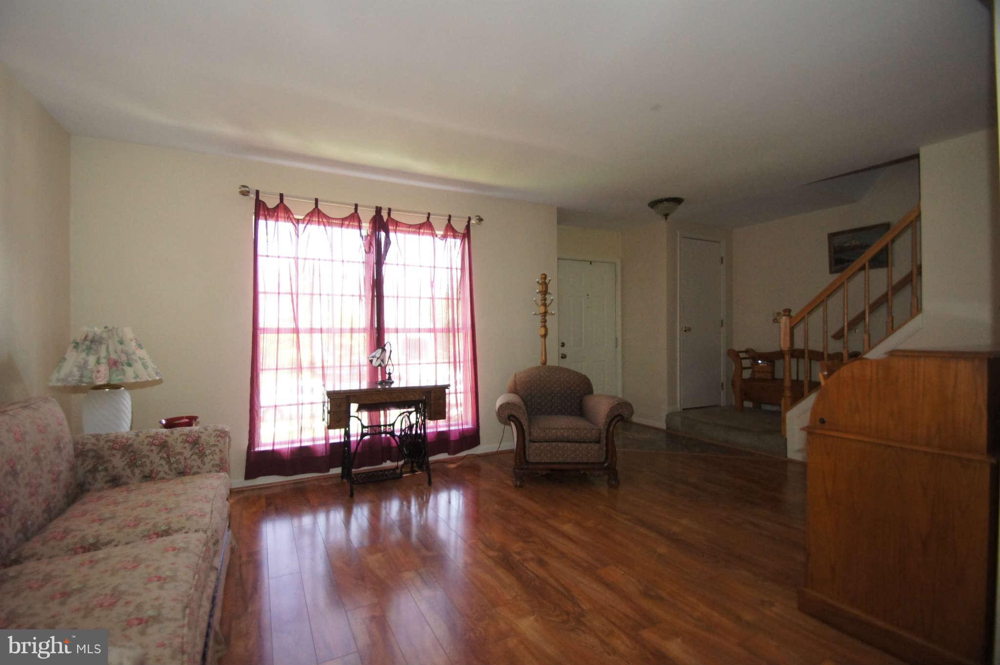 4310 Spring Avenue Baltimore, MD 21227 - Photo 3 of 30 a living room with furniture and a wooden floor