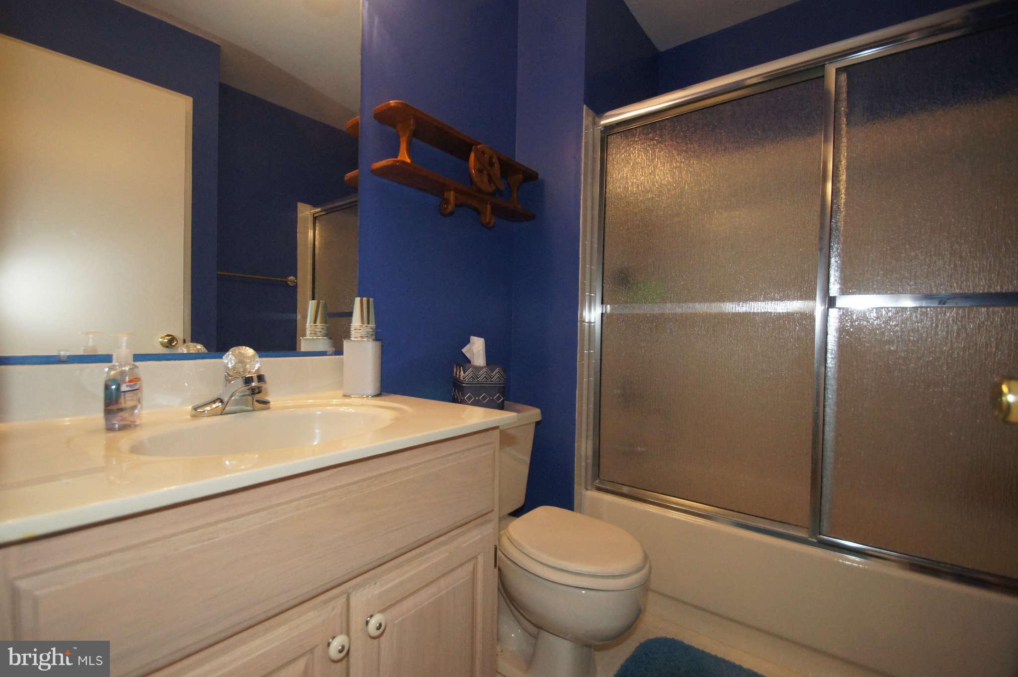 4310 Spring Avenue Baltimore, MD 21227 - Photo 22 of 30 a bathroom with a sink a toilet and shower