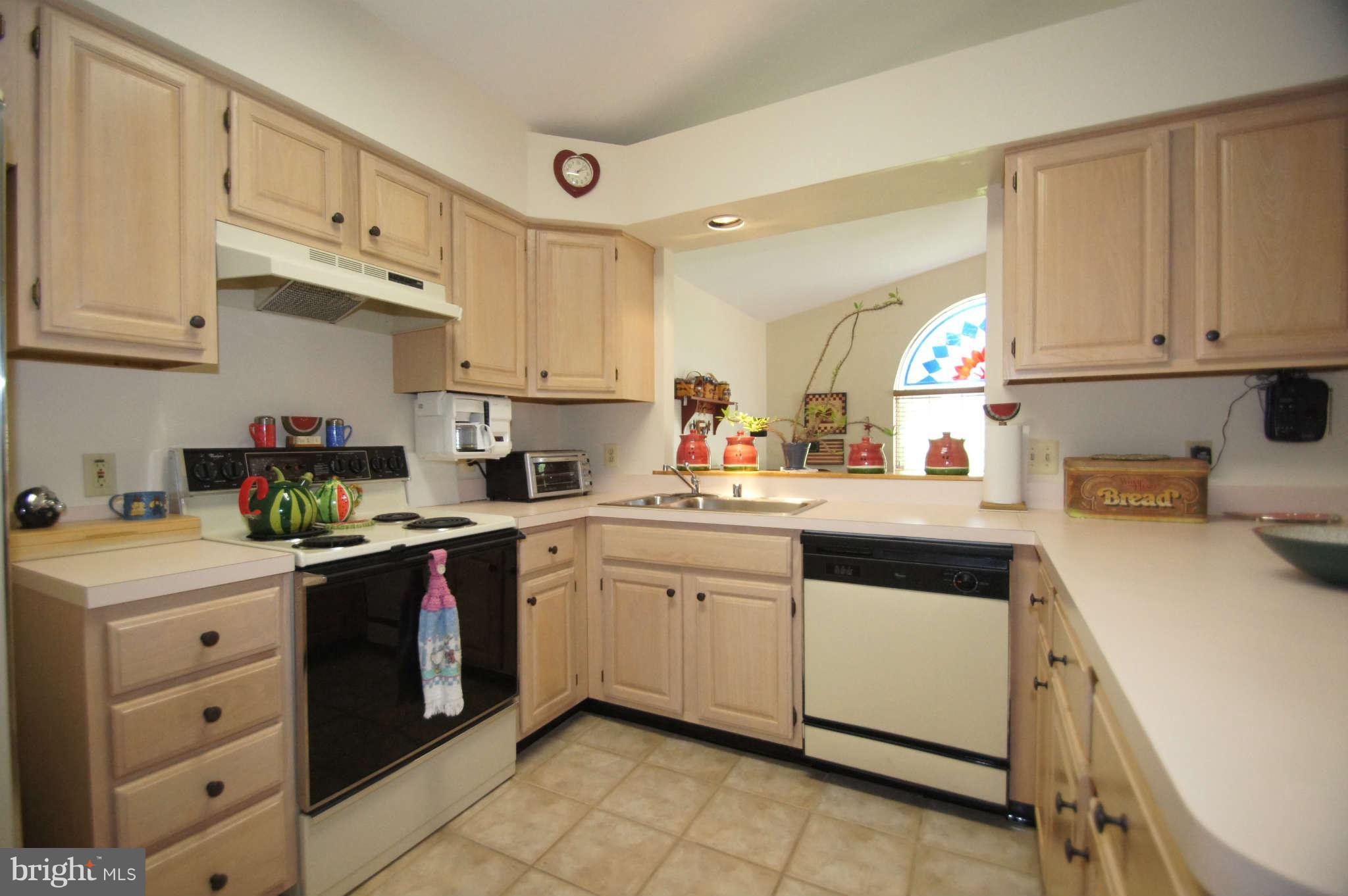4310 Spring Avenue Baltimore, MD 21227 - Photo 8 of 30 a kitchen with cabinets appliances a sink and a window