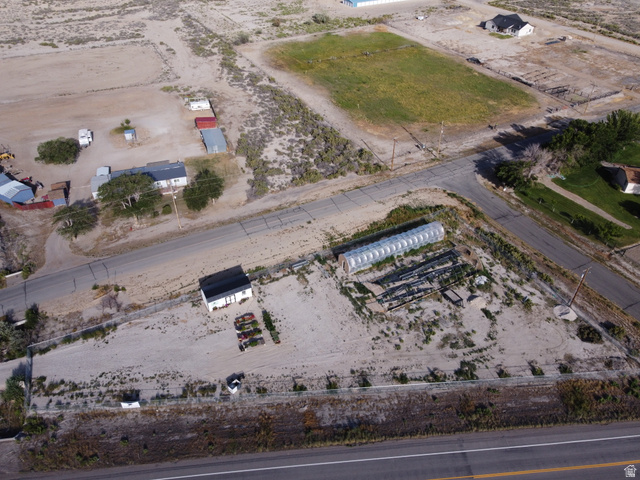 345 North Main Street Clawson, UT 84516 - Photo 5 of 17 Expansive property featuring a greenhouse structure, a white building with a black roof, and direct road frontage