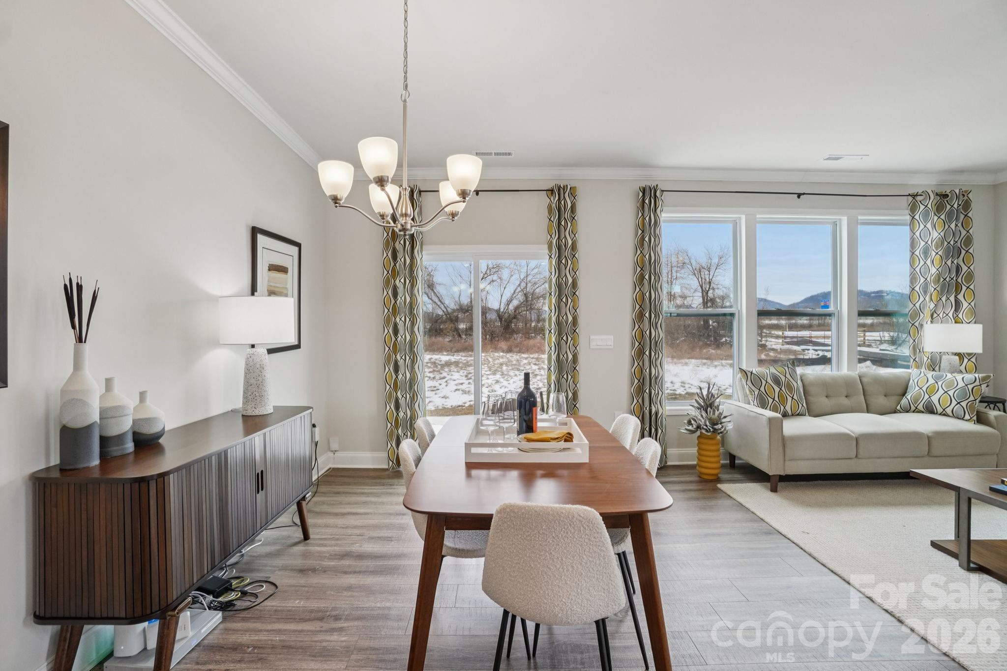 362 Lagoon Road Fletcher, NC 28732 - Photo 12 of 34 a dining room with wooden floor a chandelier a glass table and chairs