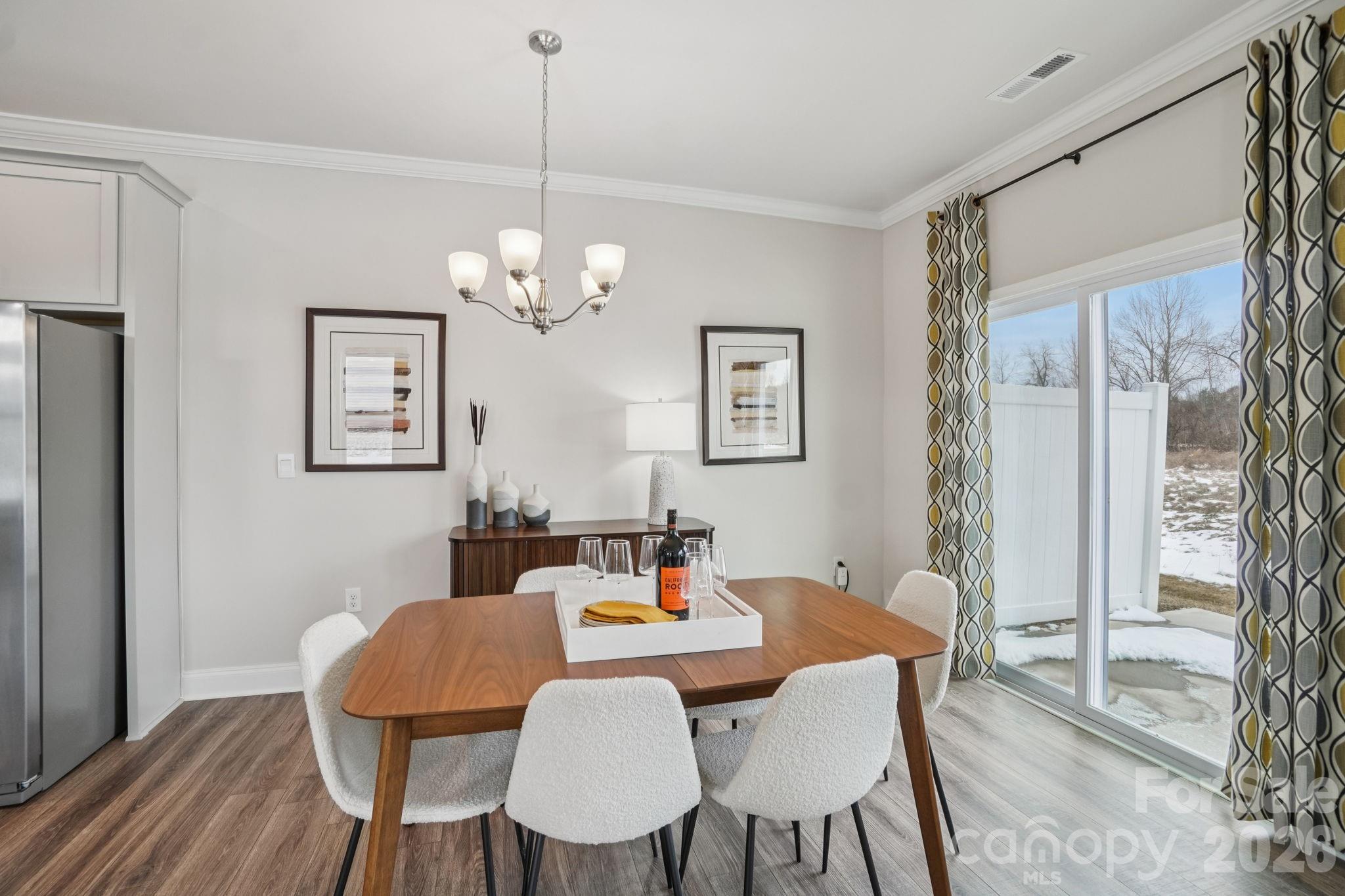 362 Lagoon Road Fletcher, NC 28732 - Photo 13 of 34 a dining room with furniture a chandelier and wooden floor