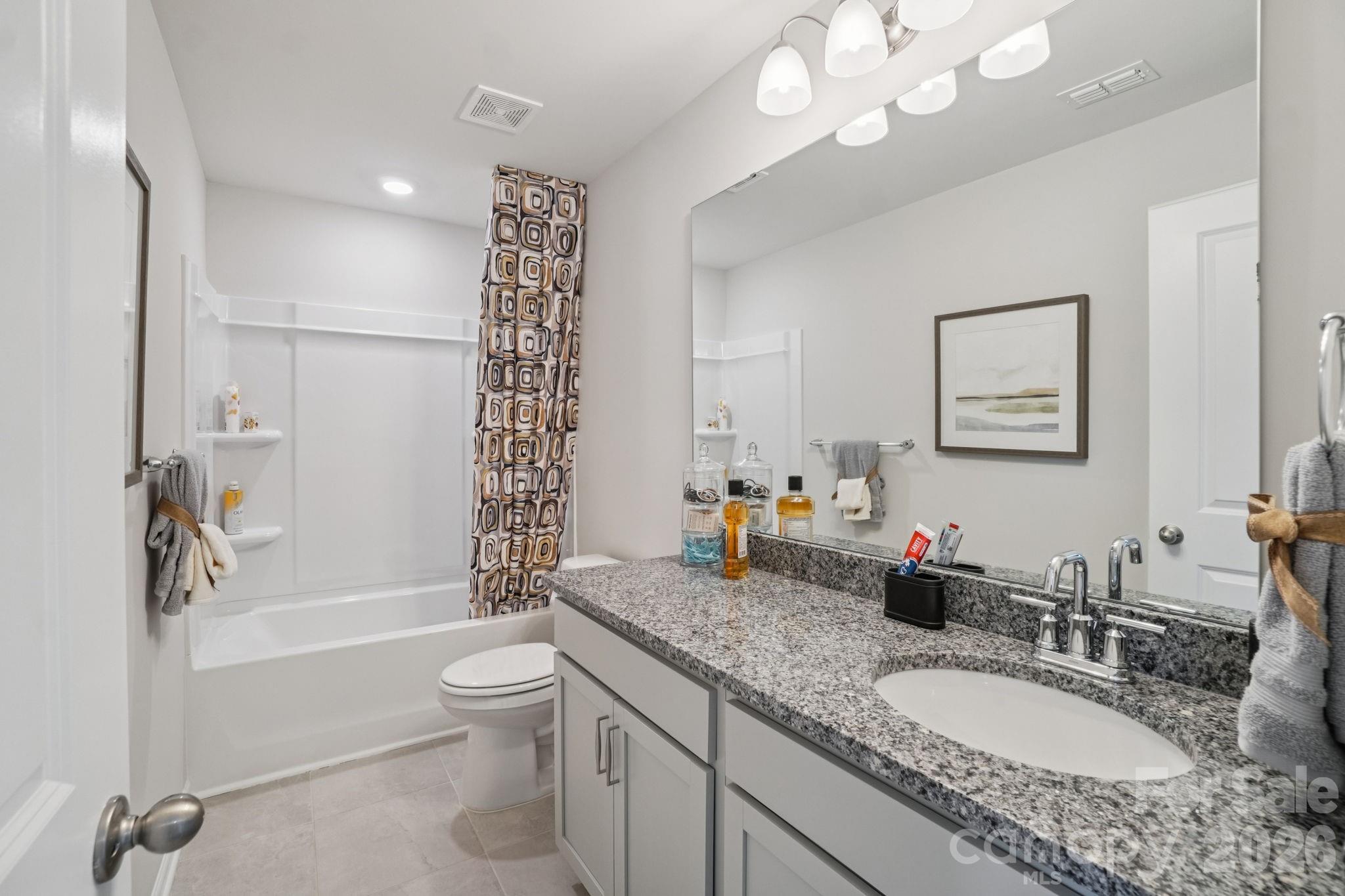 362 Lagoon Road Fletcher, NC 28732 - Photo 25 of 34 a bathroom with a granite countertop sink a toilet a tub and shower