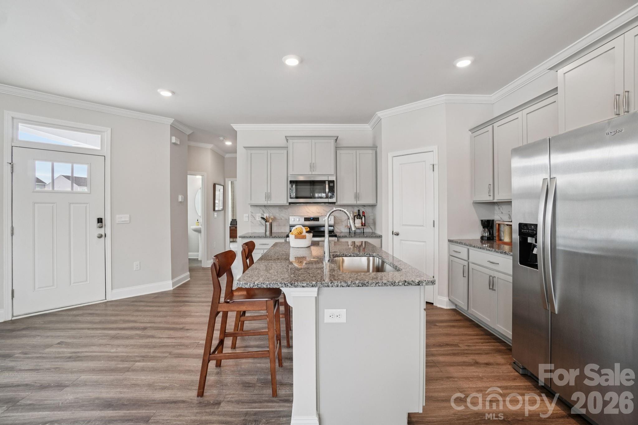 362 Lagoon Road Fletcher, NC 28732 - Photo 5 of 34 a kitchen with stainless steel appliances granite countertop a refrigerator a stove and a wooden floors