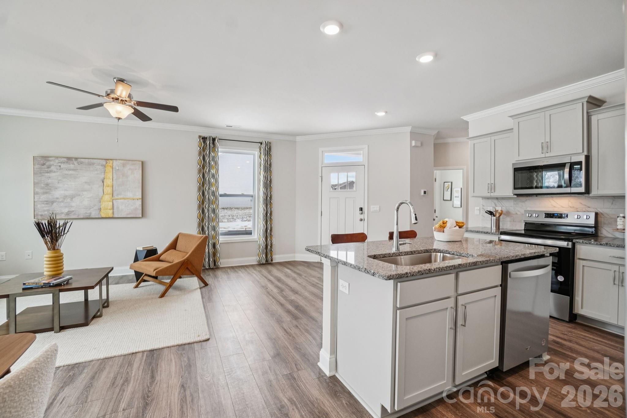 362 Lagoon Road Fletcher, NC 28732 - Photo 9 of 34 a view of living room with kitchen island stainless steel appliances furniture a fireplace and a window