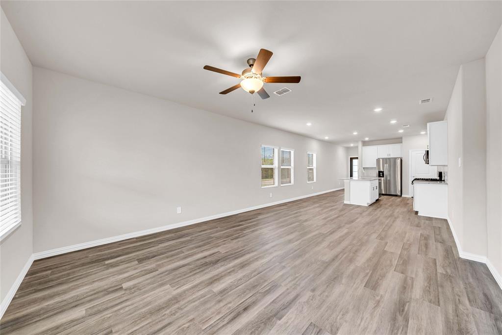 417 Martell Road Lowry Crossing, TX 75069 - Photo 13 of 29 a view of an empty room with a window and wooden floor