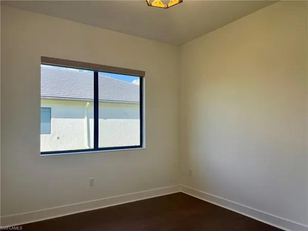 a front view of a house with a garden and plants